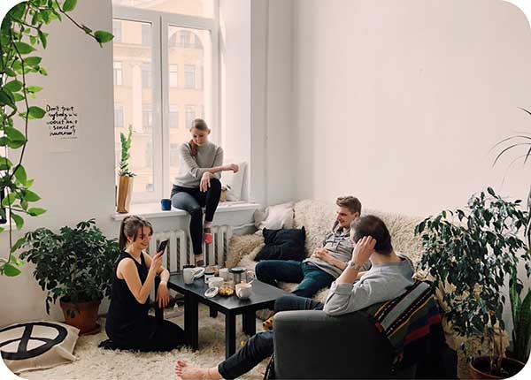 People relaxing on couch around coffee table