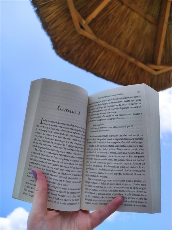 Reading a book on the beach under an umbrella